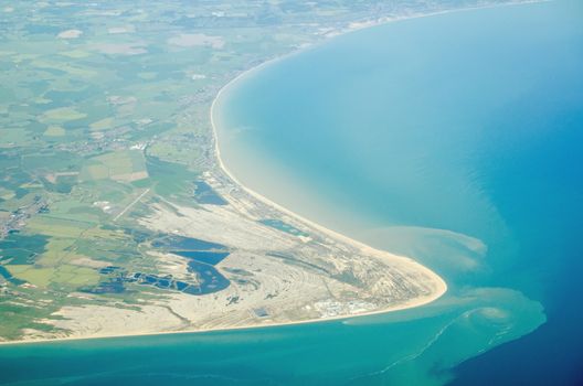 Aerial view of Dungeness headland jutting into the English Channel at Kent, England.  Towards the bottom is the Dungeness nuclear power station and to the left is London Ashford Airport.