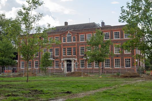 Historic building, part of the National Physical Laboratory in Teddington, West London. Undergoing some renovation work on a cloudy autumn day.