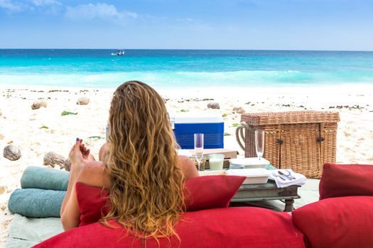 Paradise beach of Seychelles. view of woman's back admiring the sea.