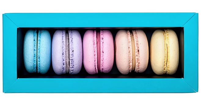 Multicolored macaroon in box top view on white background