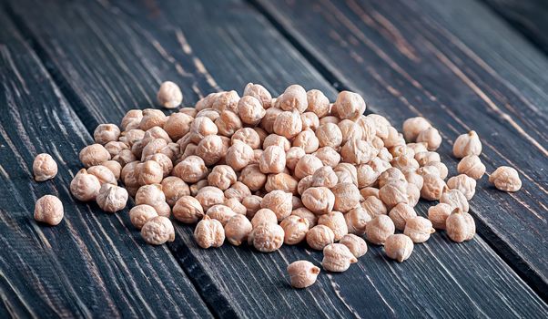 Pile of chickpeas top view on wooden background