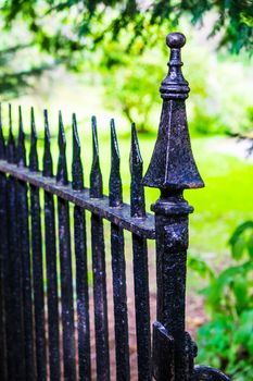 black metal fencing with spikes leading into churchyard