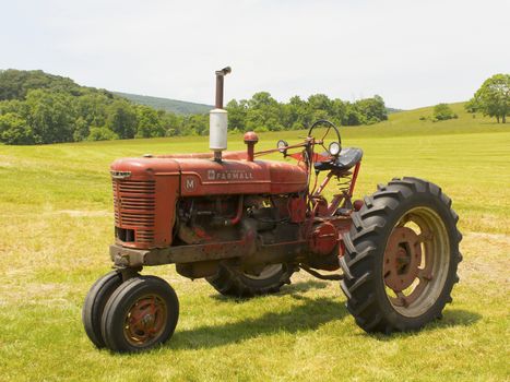 Old McCormick Farmall tractor sitting in a field