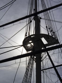 Sailing ship USS Constellation rigging backlit by sun
