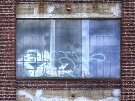 Graffiti on windows of abandoned building