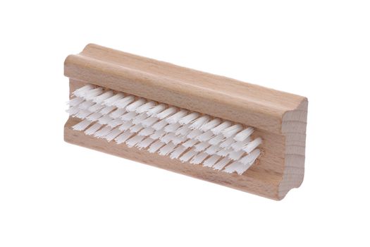 A traditional wood nail brush with short bristles inclined on a white background