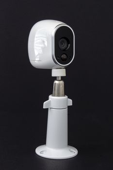 An Arlo security camera on black background