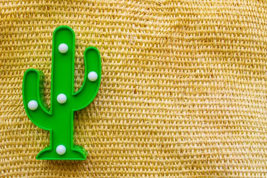 Cinco de Mayo background. A cactus on a straw rural bag background texture