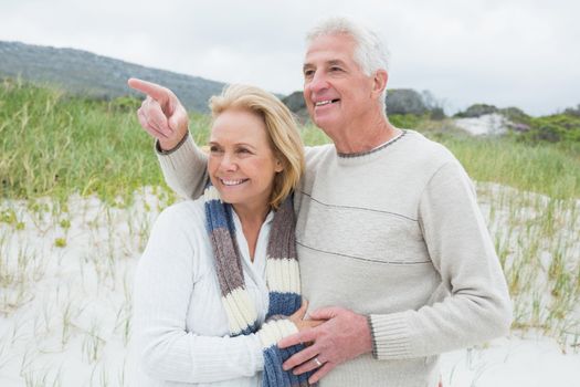 Cheerful romantic senior man and woman at the beach
