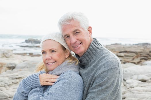 Portrait of a romantic senior couple together on a rocky beach