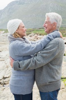 Side view of a romantic senior couple together on a rocky landscape