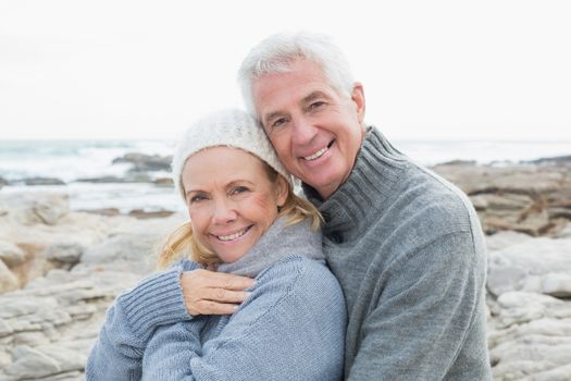 Portrait of a romantic senior couple together on a rocky beach