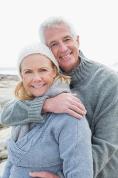Portrait of a romantic senior couple together on a rocky beach