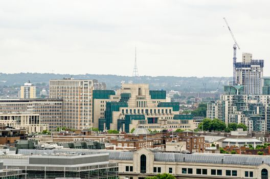 The famous headquarters of the UK's Secret Service, more commonly known as MI6 on the banks of the Thames in Lambeth.  Viewed from a tall building in Westminster with the prominent Crystal Palace television transmitter in the background. 