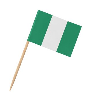 Small paper flag of Nigeria on wooden stick, isolated on white
