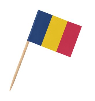 Small paper flag of Romania on wooden stick, isolated on white