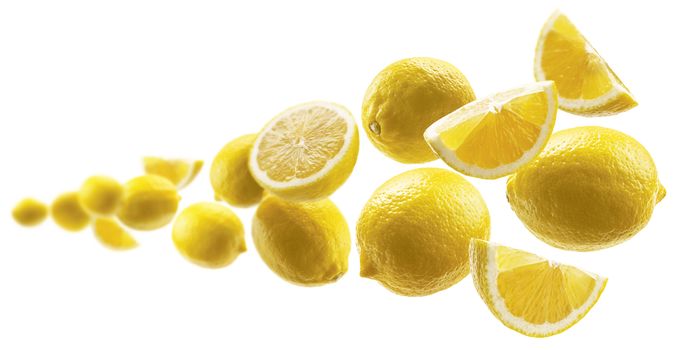 Yellow lemons levitate on a white background.