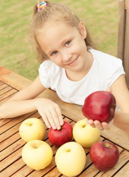 portrait of a happy child with apples