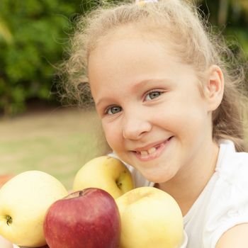 portrait of a happy child with apples