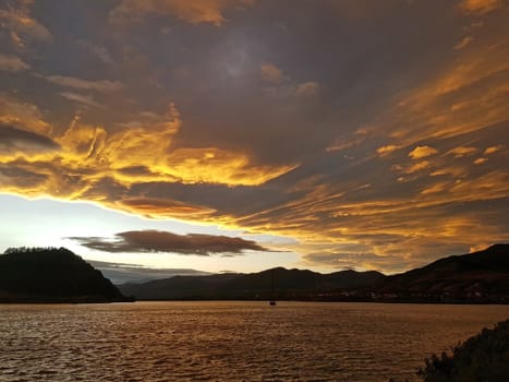 Beautiful orange clouds over the lake, at sunset.