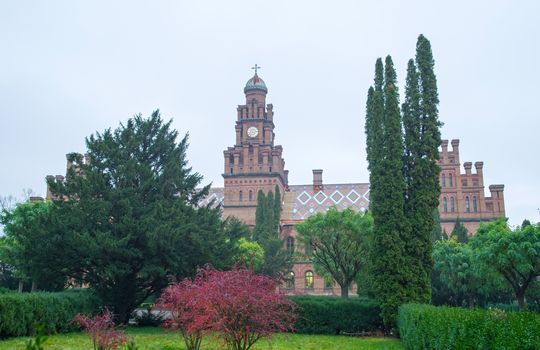 The building of Chernivtsi National University with garden in front, unesco heritage site
