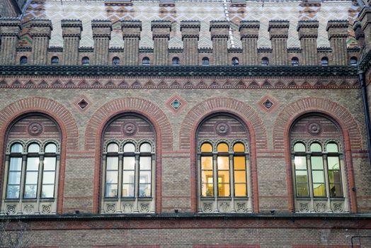 Arched windows, red brick building ornamental details at Chernivtsi National University, unesco heritage site