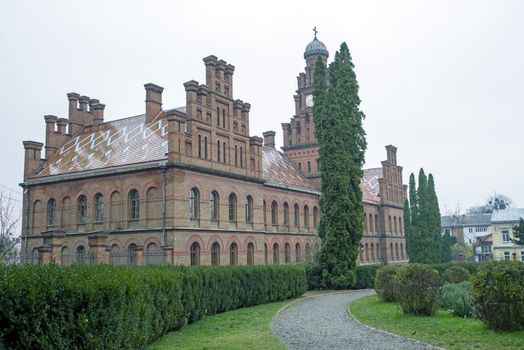 The building of Chernivtsi National University with garden in front, unesco heritage site