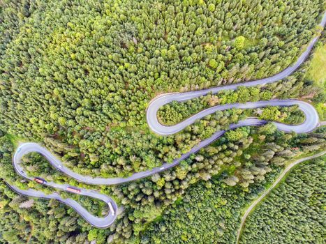 Summer mountain road view from above. mountain pass through green forest in Romania