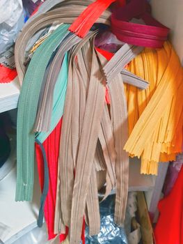 Different zippers in seamstress factory, tailor workshop