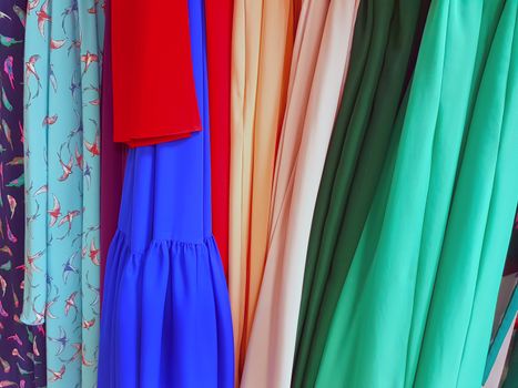 Fashion dress factory, dresses on hangers in tailor workshop