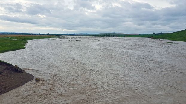 Flooding pasture  and field after heavy rainfall near farmland