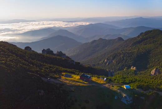 Mountain shelter and forest landscape at sunrise