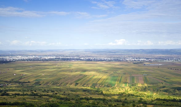 Summer landscape: cultivated fields and aerial view of Bacau, Romania