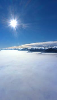 Morning sun over low clouds, drone aerial view