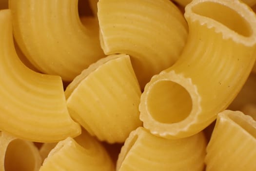 Many Horns Pasta Texture. Traditional Noodles. Uncooked Macaroni Food Background. Macro Closeup.