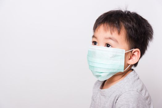 Closeup Asian face, Little children boy sick he using medicine healthcare mask on white background with copy space, health medical care