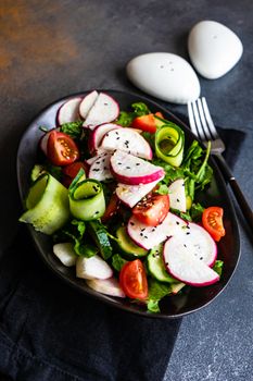 Healthy lifestyle food concept with mixed vegetable salad and seeds on rustic stone background with copy space