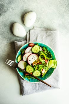 Healthy lifestyle food concept with mixed vegetable salad and seeds on rustic stone background with copy space