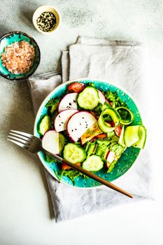 Healthy lifestyle food concept with mixed vegetable salad and seeds on rustic stone background with copy space