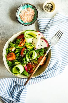 Healthy lifestyle food concept with mixed vegetable salad and seeds on rustic stone background with copy space