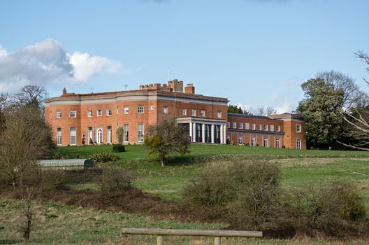 View across fields towards the historic Highfield Park stately home, now a hotel in the village of Heckfield, Hampshire. The former Prime Minister Neville Chamberlain lived and died here.  Built in the times of Queen Anne.  