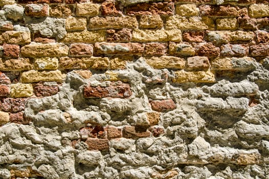 A well weathered brick wall built centuries ago in Venice, Italy.