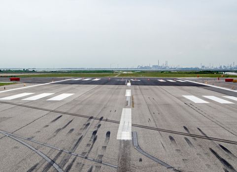 End of the runway, with skid marks from landings at Marco Polo Airport, Venice, Italy.