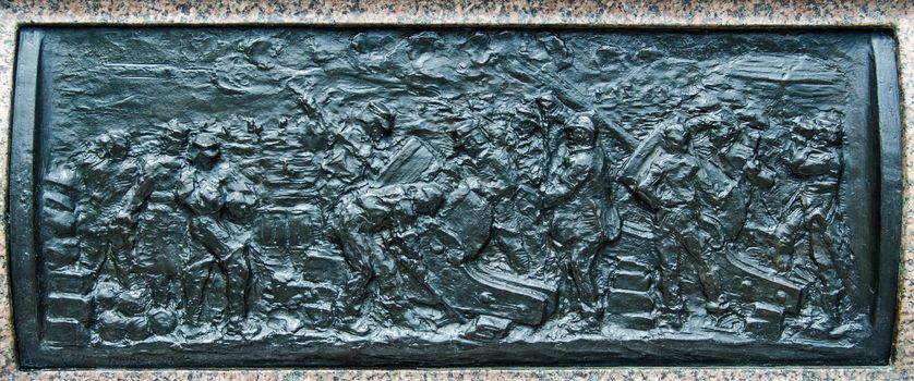Bronze frieze depicting the Siege of Sevastopol, part of the Crimean War.  Sculpted in 1904 by Henry Price and on public display on the plinth of Queen Victoria's statue at Sandhurst Military Academy, Berkshire.