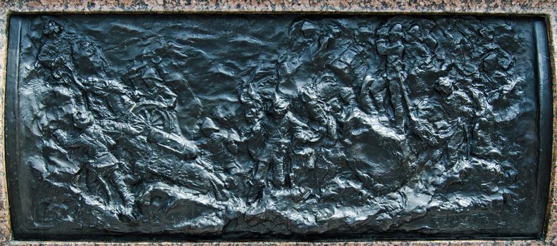 A bronze frieze depicting a Mountain Battery in Afghanistan, sculpted in 1904 by Henry Price and on public display on the plinth of Queen Victoria's statue at Sandhurst Military Academy, Berkshire.