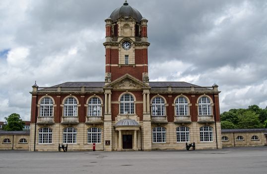 Historic Victorian building with clocktower forming part of  New College at the Royal Military Academy in Sandhurst, Berkshire where officers are trained for the British Army.