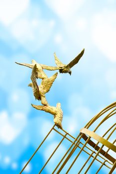 gold Sculpture of a Dove Being Set Free