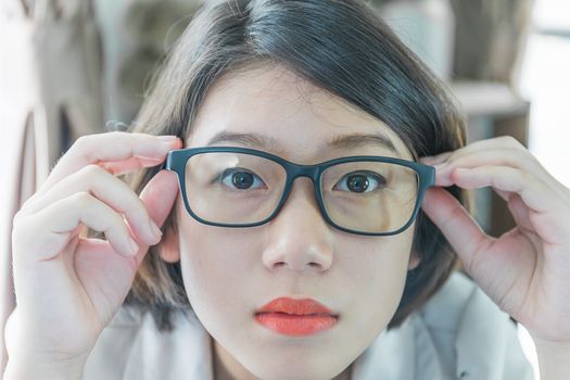 Teenage girl short hair relaxed after working on laptop while sit near window at home office