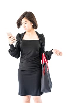 Woman carrying a black shopping bag using cellphone shopping online isolate on white background