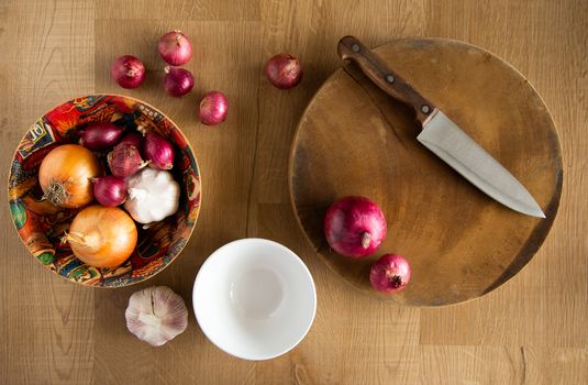 Cutting an onion on chopping board